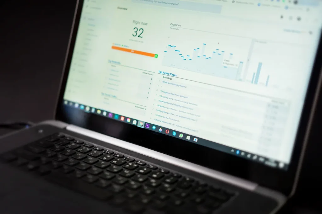 A laptop displaying website analytics in an illustrative workspace.
